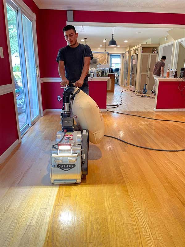 Refinish My Floors technician running a floor sander in a Bethesda, MD home