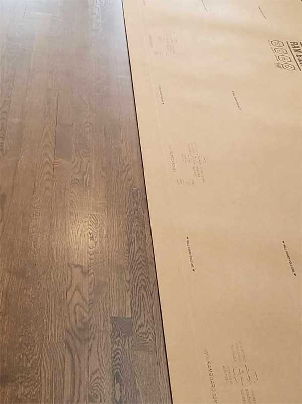 Freshly sanded hardwood boards beside protective paper in Bethesda, MD