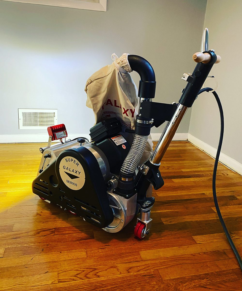 Floor sander on a hardwood floor in a Maryland home