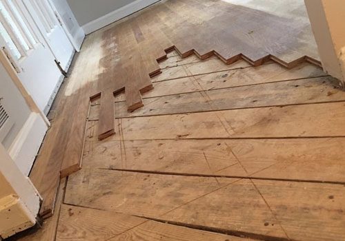 Subfloor with hardwood boards being replaced during floor repair