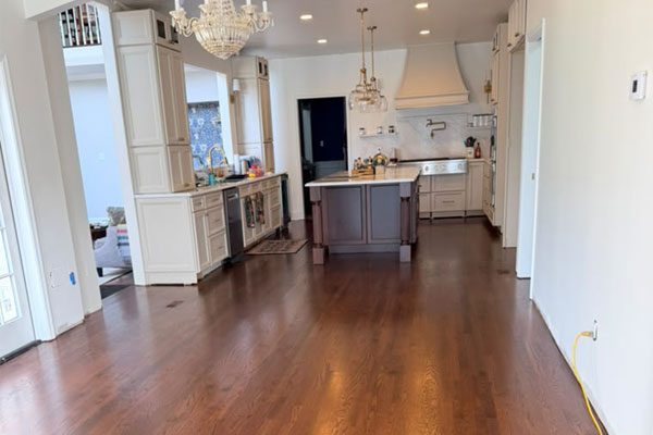 Kitchen with refinished dark hardwood floors after reconstruction