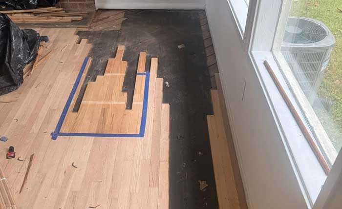 Hardwood floor board repair in progress in Rockville, MD