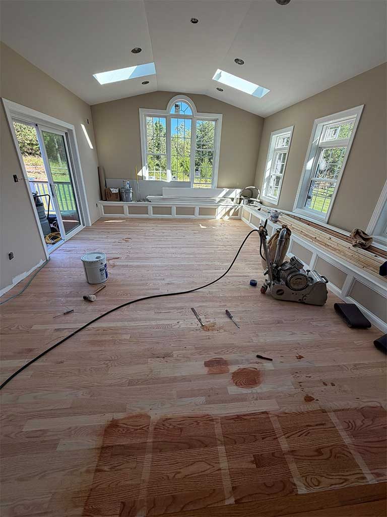 Hardwood floor being sanded in a Silver Spring, MD sunroom